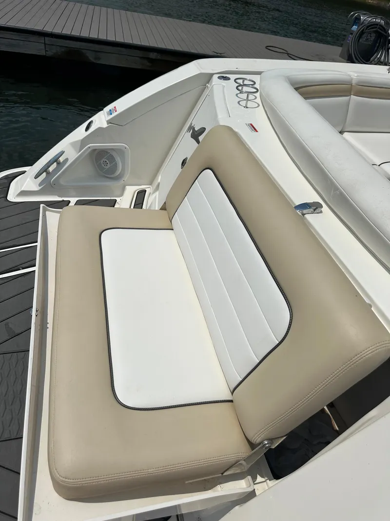 Slide: The Image of 2008 Sea Ray 350 Sundancer boat seating, beige and white upholstery, docked by the water. - 16