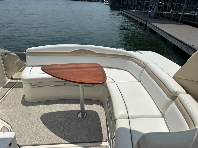 Slide: The Image of 2008 Sea Ray 350 Sundancer boat with white seating and wooden table on deck. - 18