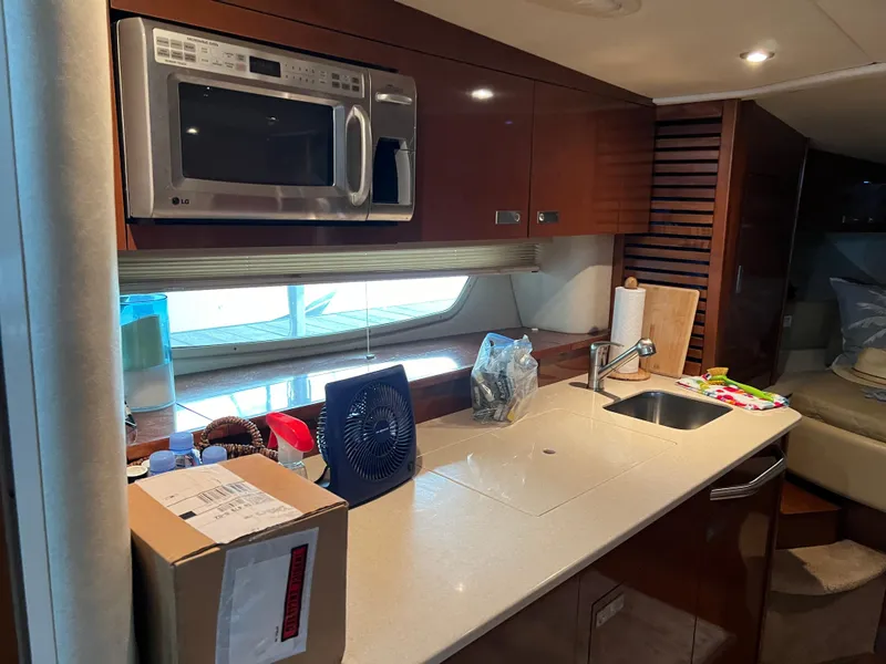 Slide: The Image of 2008 Sea Ray 350 Sundancer kitchen with microwave, sink, and countertop. - 20