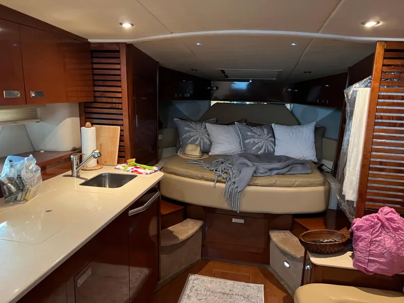 Slide: The Image of Interior of 2008 Sea Ray 350 Sundancer yacht with cozy bed and kitchenette. - 21