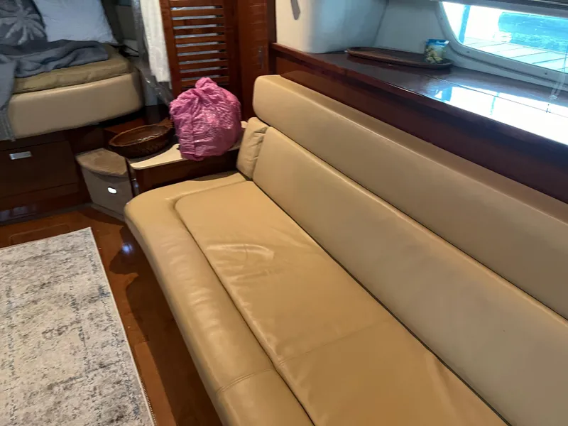 Slide: The Image of Interior of 2008 Sea Ray 350 Sundancer with beige leather sofa and wooden accents. - 23