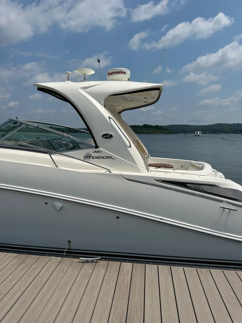 Slide: The Image of 2008 Sea Ray 350 Sundancer docked by a serene lake under a blue sky. - 5