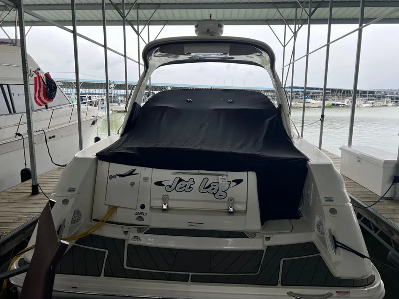 Slide: The Image of 2008 Sea Ray 350 Sundancer docked, rear view with cover, named Jet Lag. - 7