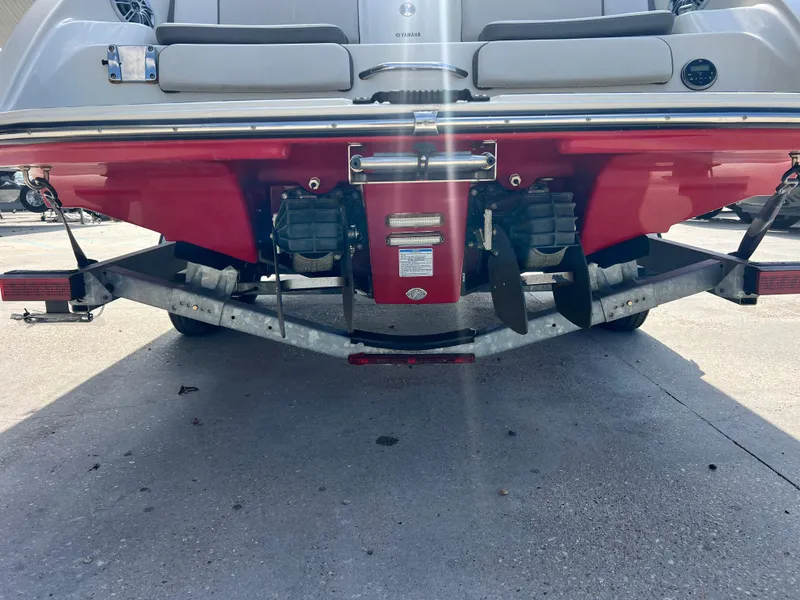 Slide: The Image of 2014 Yamaha Boats 242 Limited S rear view, showcasing dual engines and red hull. - 8