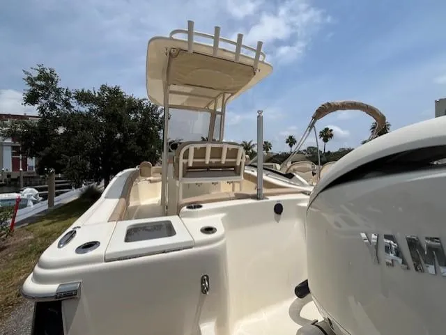Slide: The Image of 2024 Scout 215XSF boat with Yamaha engine, docked outdoors. - 17