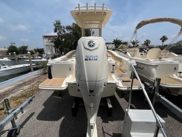 Slide: The Image of 2024 Scout 215XSF boat with Yamaha 200 outboard motor, docked at marina. - 3