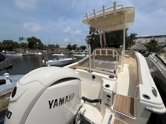 Slide: The Image of 2024 Scout 215XSF boat with Yamaha engine docked at marina. - 4