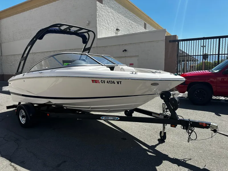 The Image of 2018 Regal 1900 ES Bowrider boat on trailer in parking lot. - 1