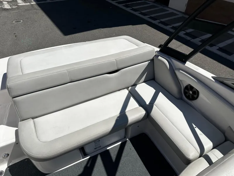 Slide: The Image of 2018 Regal 1900 ES Bowrider interior seating area with white and gray upholstery. - 12