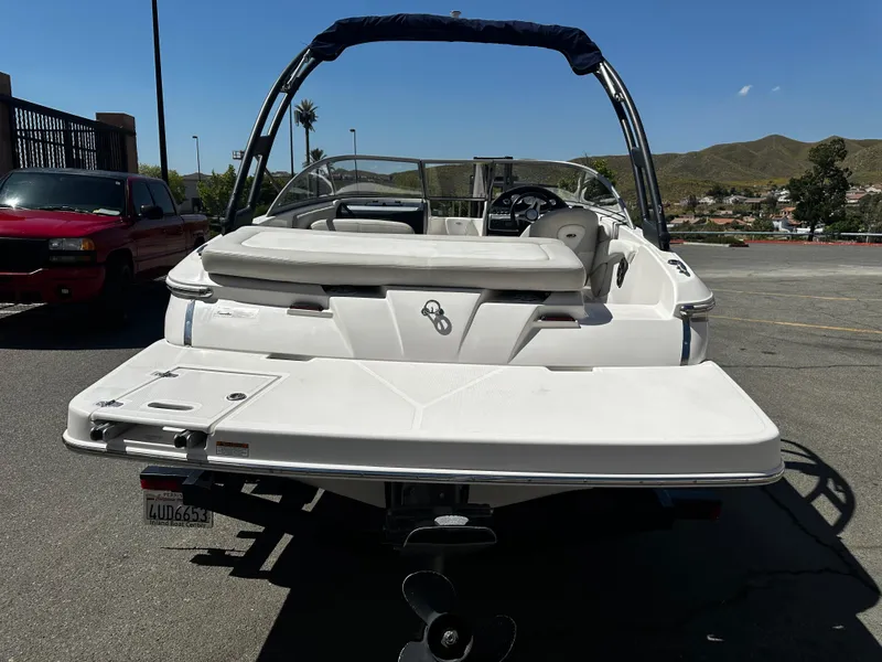 Slide: The Image of 2018 Regal 1900 ES Bowrider boat, rear view, parked on a sunny day. - 4