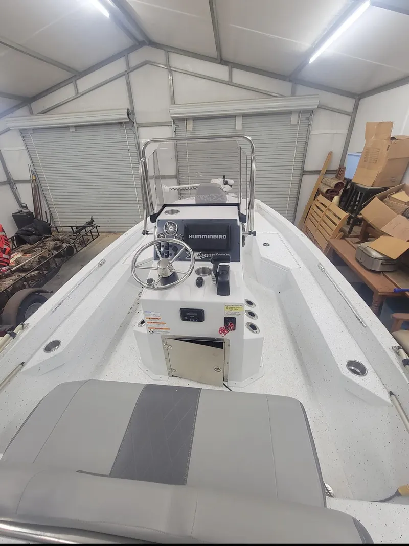 Slide: The Image of 2021 Xpress H20B boat in a storage garage. - 2