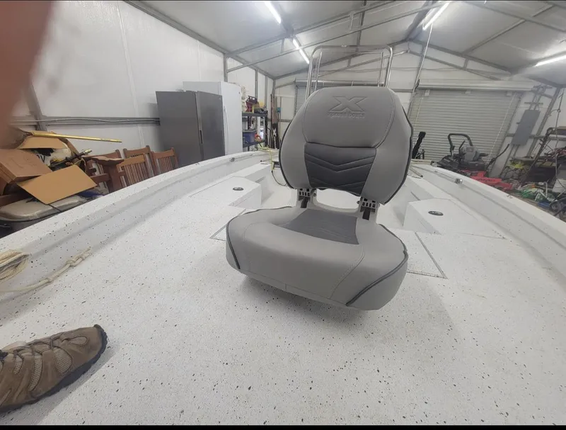 Slide: The Image of 2021 Xpress H20B boat seat in a garage. - 4
