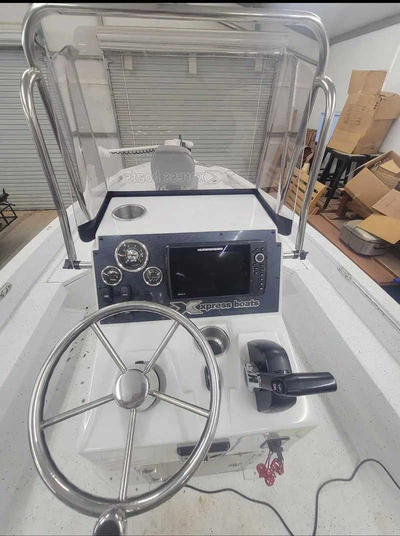 Slide: The Image of 2021 Xpress H20B boat console with steering wheel and control panel. - 5