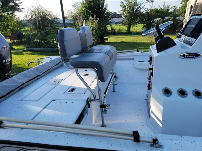 Slide: The Image of 2021 Xpress H20B boat with seating and control console in a grassy yard. - 6