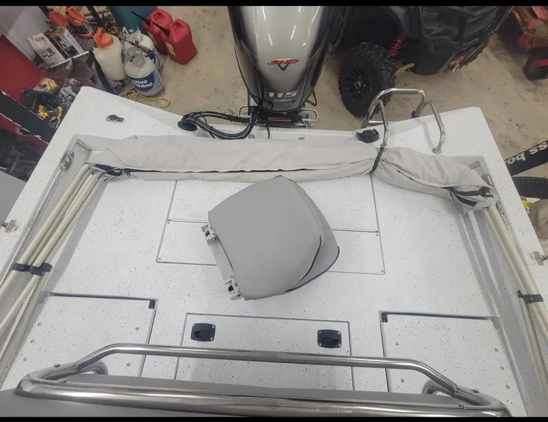 Slide: The Image of 2021 Xpress H20B boat deck with Yamaha outboard motor in a garage. - 7