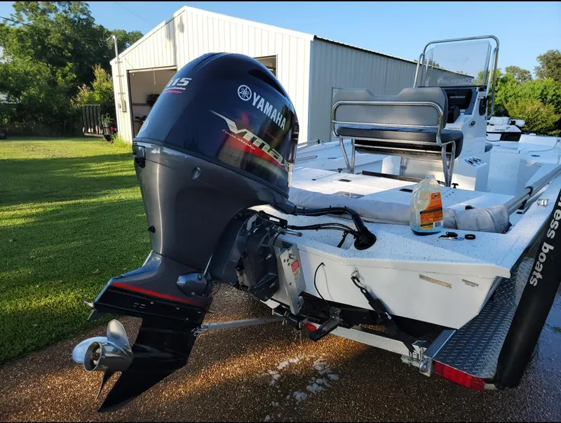 Slide: The Image of 2021 Xpress H20B boat with Yamaha 115 outboard motor in a driveway. - 8
