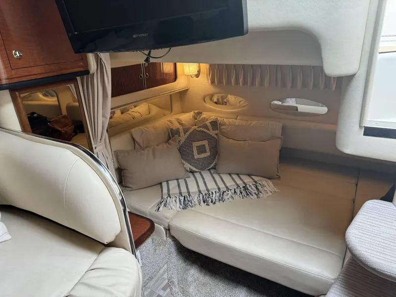 Slide: The Image of Interior of 2002 Sea Ray 310 Sundancer with cozy seating and TV. - 6