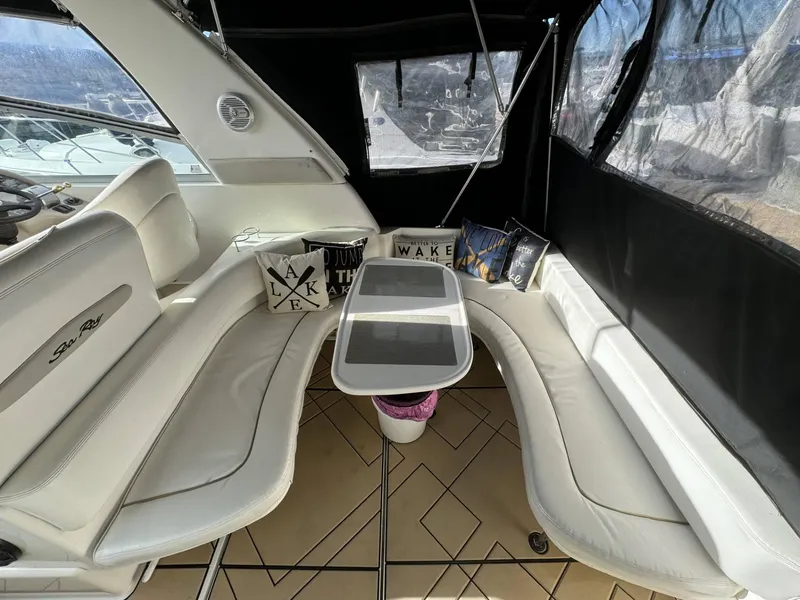 Slide: The Image of Interior seating area of a 2002 Sea Ray 310 Sundancer with white cushions and decorative pillows. - 7