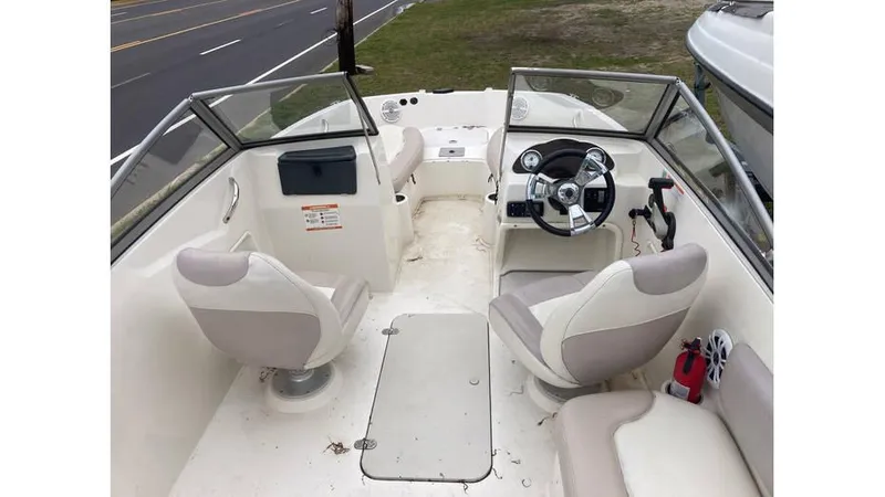 Slide: The Image of 2019 Stingray 190 DC boat interior with steering wheel and seating. - 6