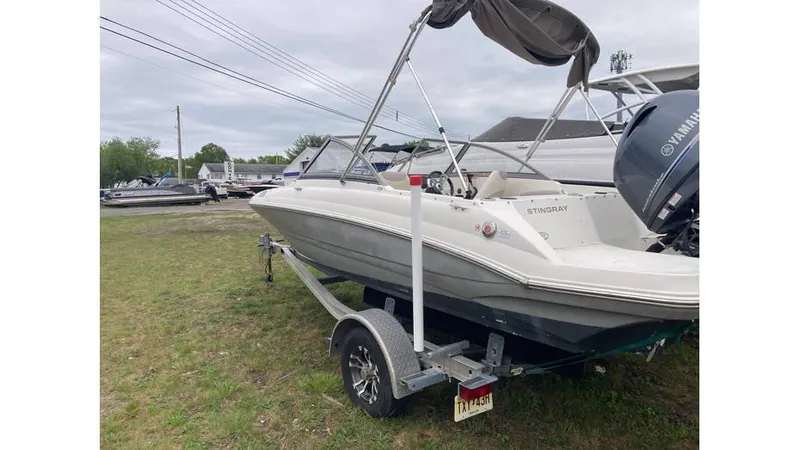Slide: The Image of 2019 Stingray 190 DC boat on trailer with Yamaha outboard motor. - 2