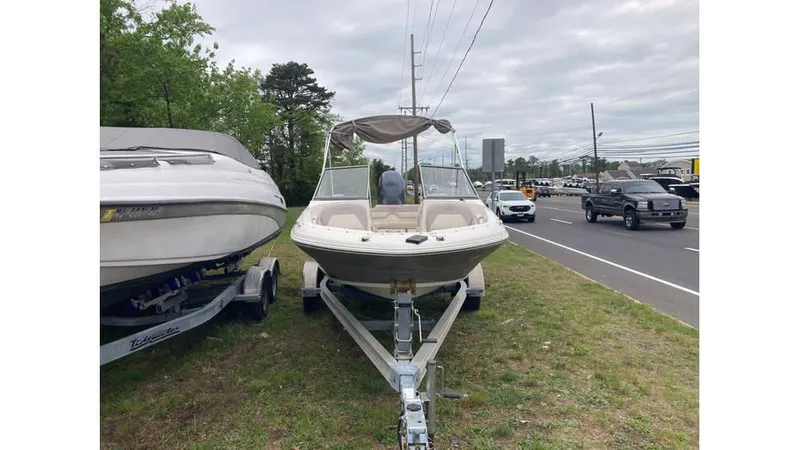 Slide: The Image of 2019 Stingray 190 DC boat on trailer by roadside. - 4