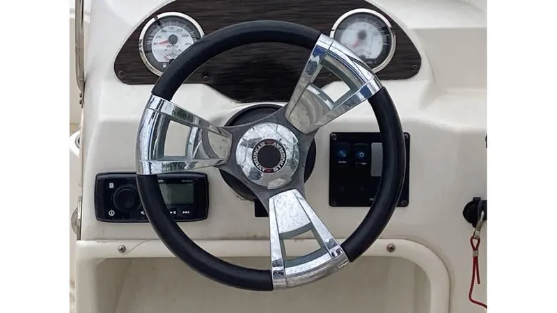 Slide: The Image of Steering wheel and dashboard of a 2019 Stingray 190 DC boat. - 7