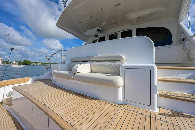 Slide: The Image of 2018 Viking 92 Sky Bridge yacht with spacious deck and seating area. - 14