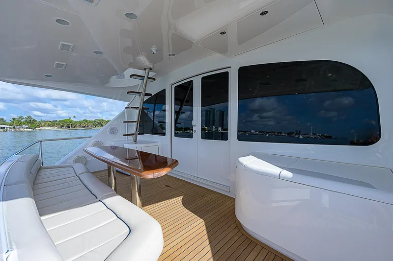Slide: The Image of 2018 Viking 92 Sky Bridge yacht with spacious deck and luxurious seating. - 17