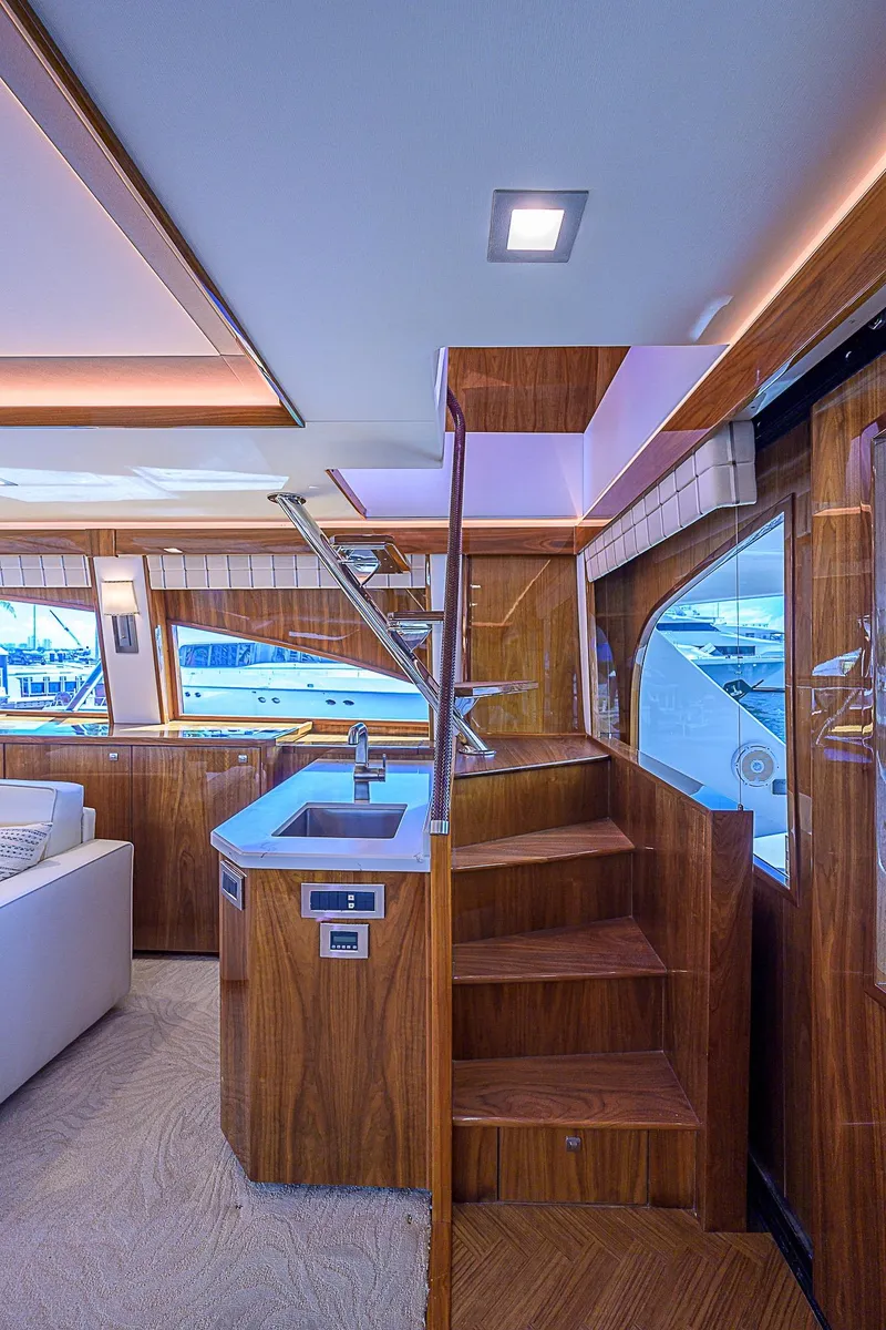 Slide: The Image of Luxurious interior of 2018 Viking 92 Sky Bridge yacht with wooden stairs and modern design. - 19