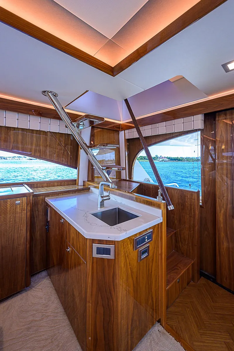 Slide: The Image of Interior of 2018 Viking 92 Sky Bridge yacht with modern kitchen and ocean view. - 21