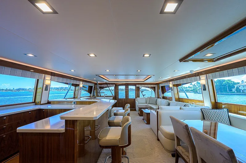 Slide: The Image of Luxurious interior of 2018 Viking 92 Sky Bridge yacht with modern seating and panoramic windows. - 22