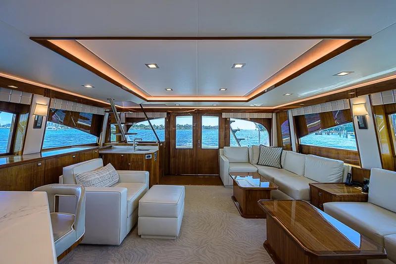 Slide: The Image of Luxurious interior of 2018 Viking 92 Sky Bridge yacht with elegant seating and panoramic windows. - 23
