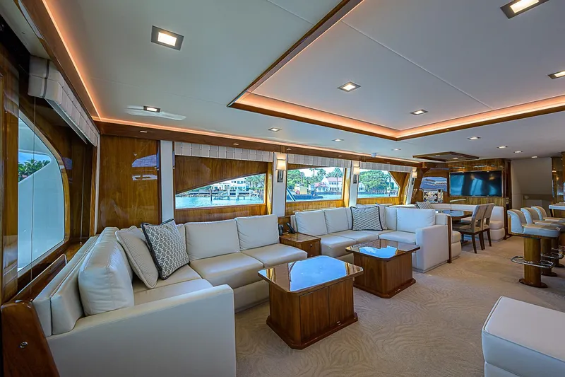 Slide: The Image of Luxurious interior of 2018 Viking 92 Sky Bridge yacht with elegant seating and large windows. - 25