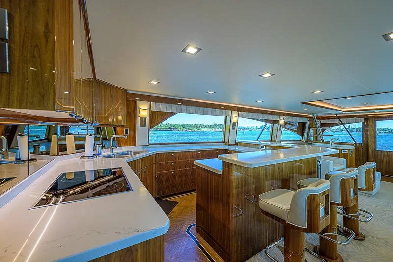 Slide: The Image of Luxurious interior of 2018 Viking 92 Sky Bridge yacht with modern kitchen and ocean view. - 29