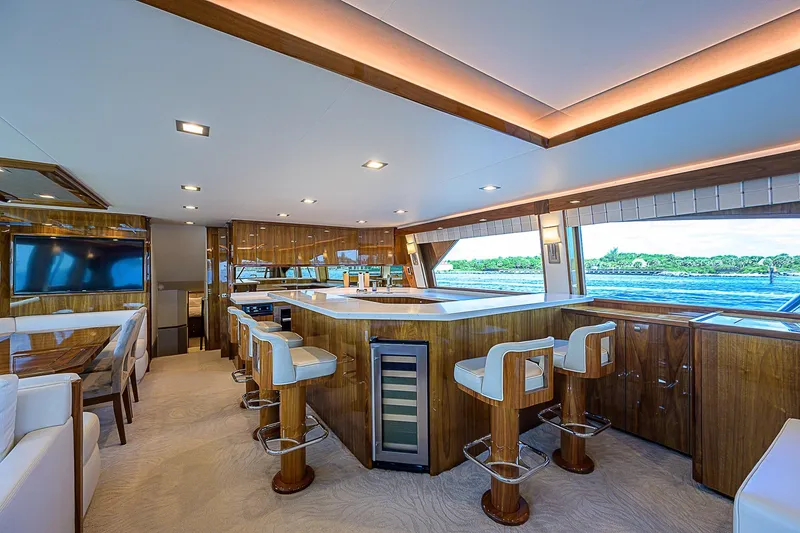 Slide: The Image of Luxurious interior of 2018 Viking 92 Sky Bridge yacht with modern kitchen and seating area. - 30