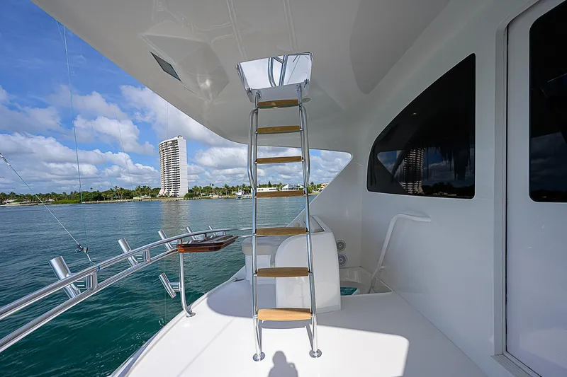 Slide: The Image of Ladder on the deck of a 2018 Viking 92 Sky Bridge yacht with ocean view. - 37