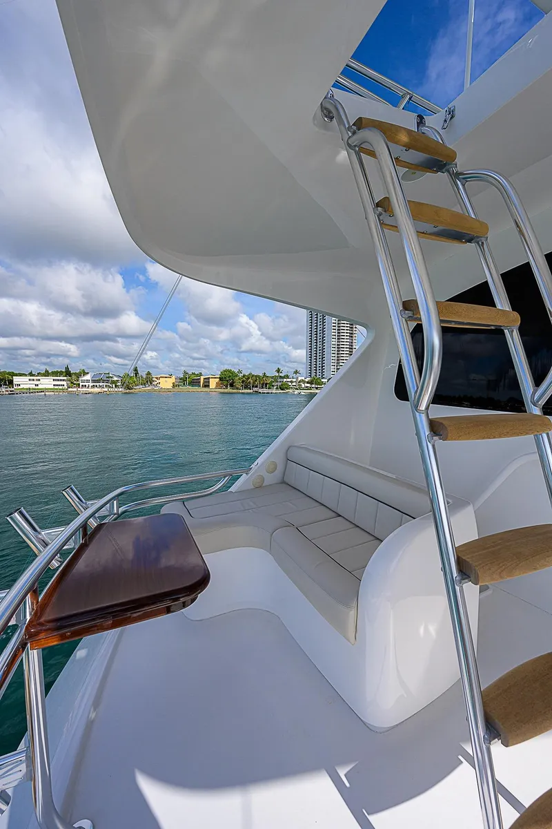 Slide: The Image of 2018 Viking 92 Sky Bridge yacht with seating area and ladder. - 38