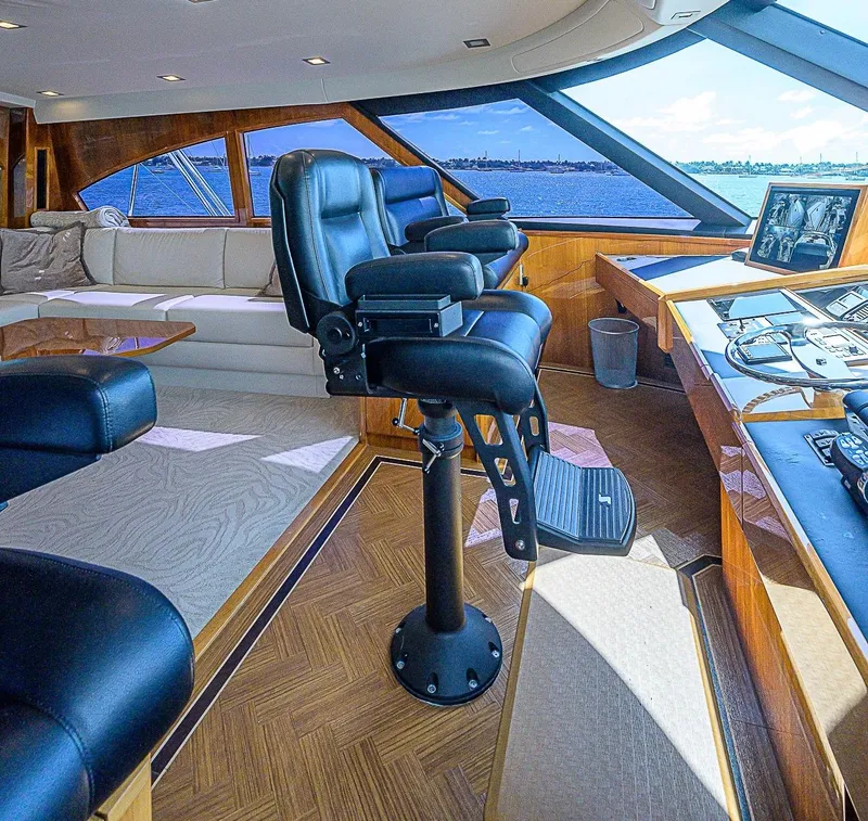 Slide: The Image of Luxurious interior of 2018 Viking 92 Sky Bridge yacht with captain's chairs and panoramic windows. - 42