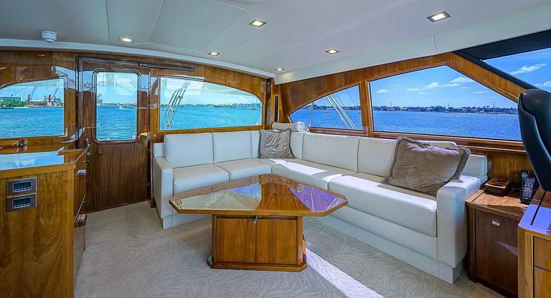 Slide: The Image of Luxurious interior of a 2018 Viking 92 Sky Bridge yacht with white leather seating and wooden accents. - 43