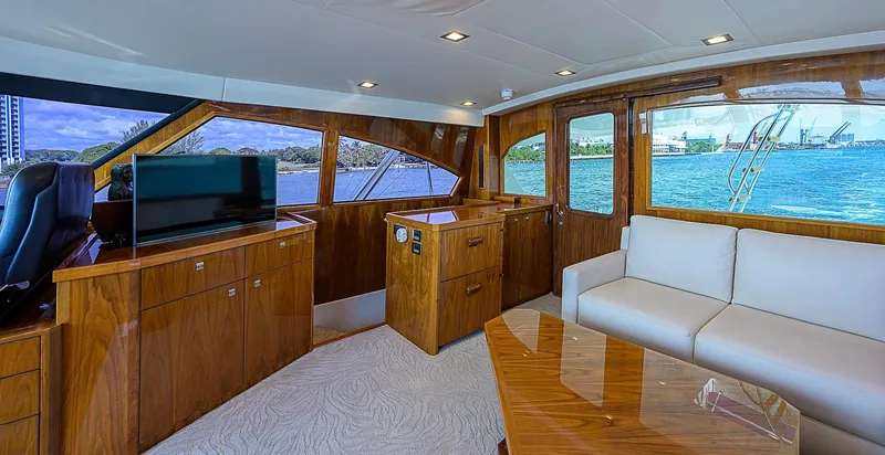 Slide: The Image of Luxurious interior of 2018 Viking 92 Sky Bridge yacht with wood finishes and waterfront view. - 44
