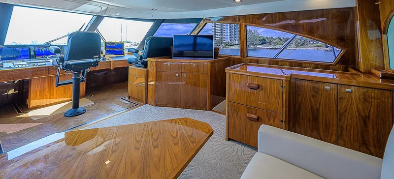 Slide: The Image of Luxurious interior of a 2018 Viking 92 Sky Bridge yacht with polished wood finishes. - 45