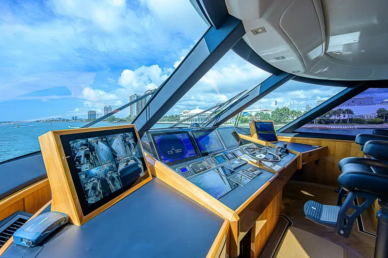 Slide: The Image of 2018 Viking 92 Sky Bridge yacht helm with advanced navigation systems and panoramic views. - 49