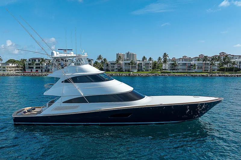 Slide: The Image of 2018 Viking 92 Sky Bridge yacht cruising near luxury waterfront properties. - 8