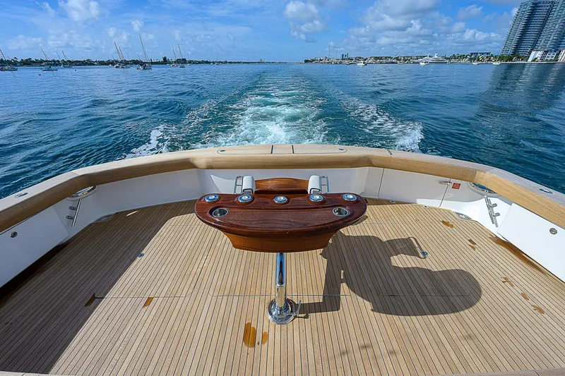 Slide: The Image of Aft deck of 2018 Viking 92 Sky Bridge yacht cruising on open water. - 9