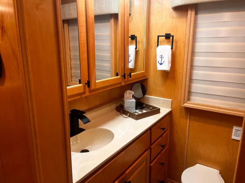 Slide: The Image of 2004 Starlight 68X16 bathroom with wooden cabinets and modern fixtures. - 13