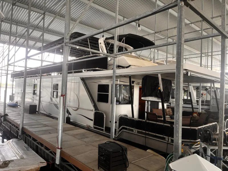 Slide: The Image of 2004 Starlight 68X16 houseboat docked in a covered marina. - 2