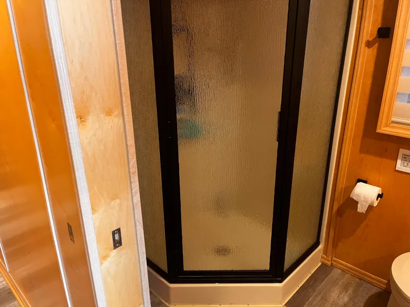 Slide: The Image of Compact bathroom with corner shower in 2004 Starlight 68X16 mobile home. - 20