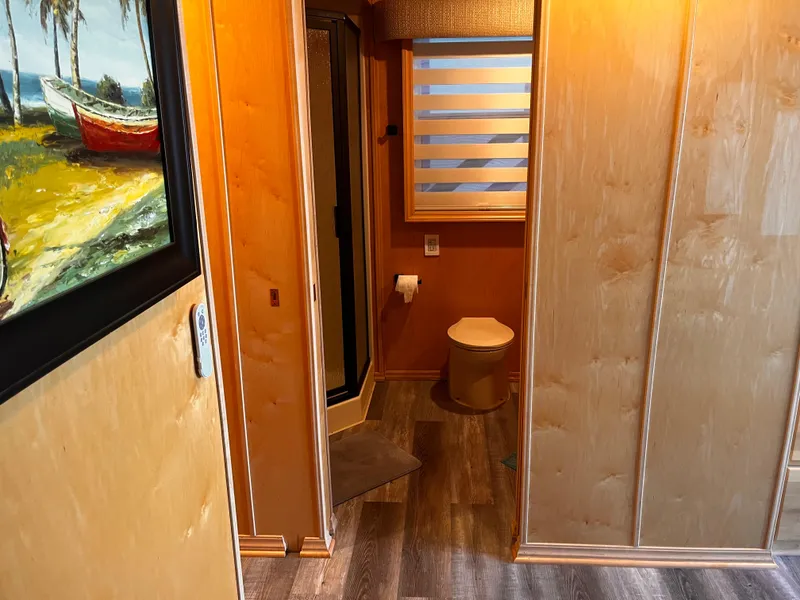 Slide: The Image of Compact bathroom in a 2004 Starlight 68X16 mobile home with wood paneling and modern fixtures. - 21