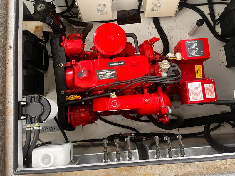 Slide: The Image of 2004 Starlight 68X16 engine compartment with red engine and components. - 24