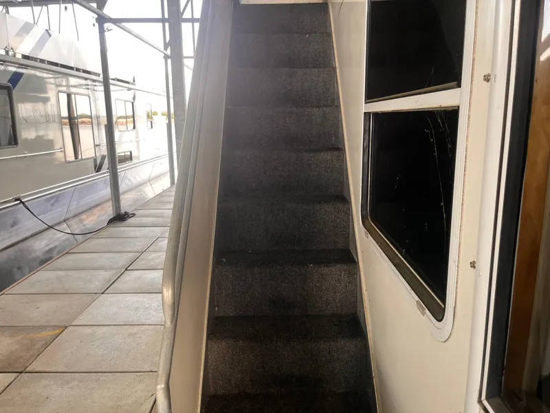 Slide: The Image of Staircase on a 2004 Starlight 68X16 houseboat docked at a marina. - 28